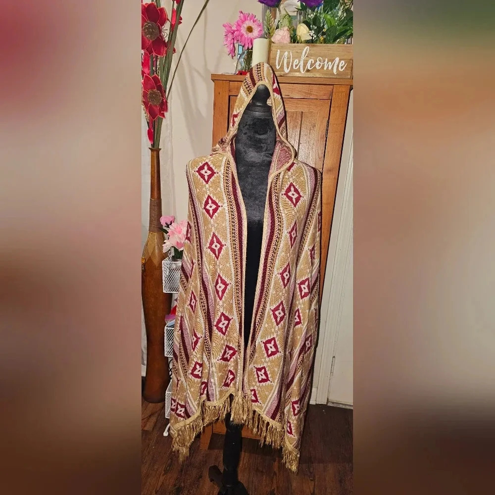 A Papaya Fashion poncho with hood. One size fits all.